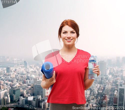 Image of smiling girl with bottle of water after exercising