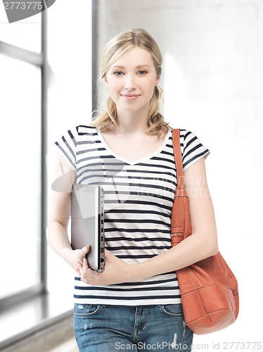 Image of happy and smiling teenage girl with laptop