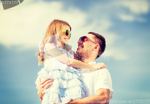 Image of happy father and child in sunglasses over blue sky