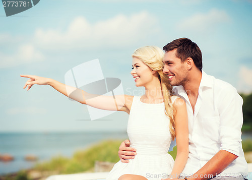 Image of couple sitting at sea side