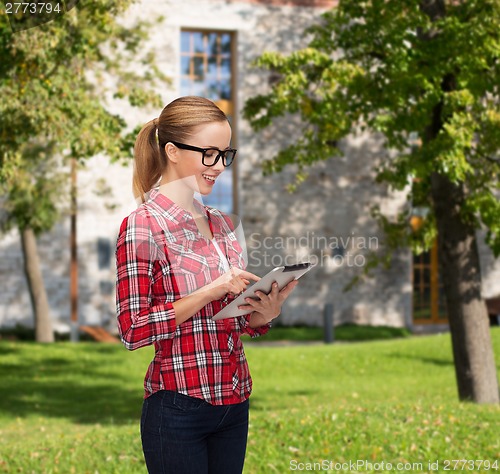 Image of smiling girl in eyeglasses with tablet pc computer