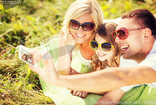 Image of happy family with camera taking picture