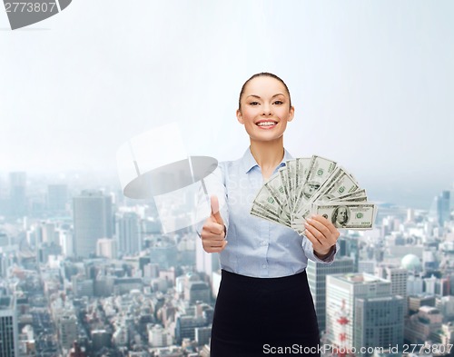 Image of young businesswoman with dollar cash money