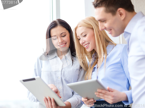 Image of business team working with tablet pcs in office