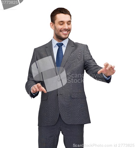 Image of businessman working with imaginary virtual screen