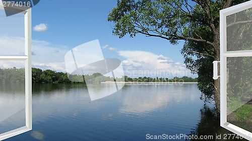 Image of opened window to the summer field