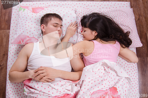 Image of Lovers sleeping in bed