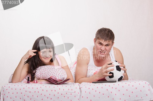 Image of Male football fan, wife hates this game