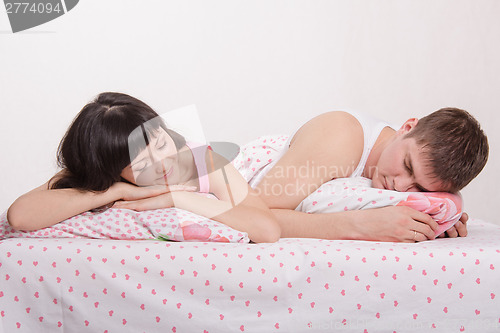 Image of Young couple sleeping in bed