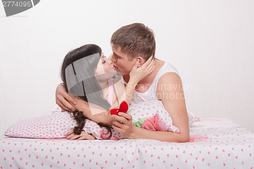 Image of Girl in bed agrees to a marriage proposal