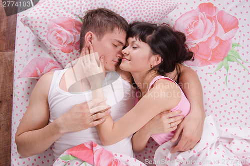 Image of Two young men sleeping in bed