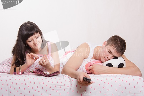 Image of Husband was asleep in bed, looking uninteresting football