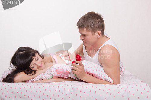 Image of guy gently awakens in his girlfriend's birthday