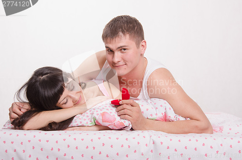 Image of Man preparing to wake her and give an engagement ring