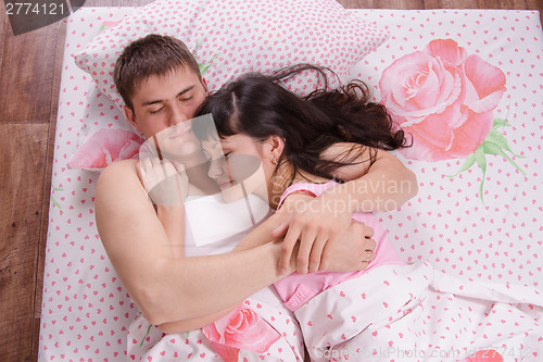 Image of Young beautiful couple sleeping in bed