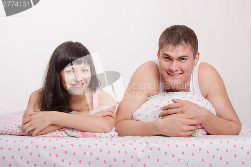 Image of Happy young man and woman in bed