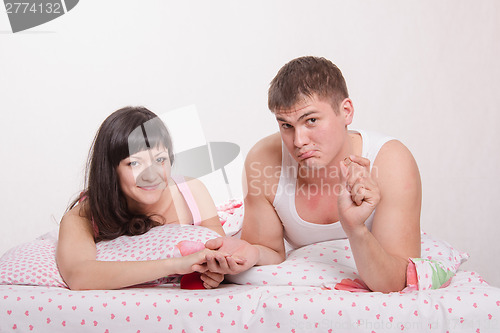 Image of Groom getting ready to put ring on bride's finger