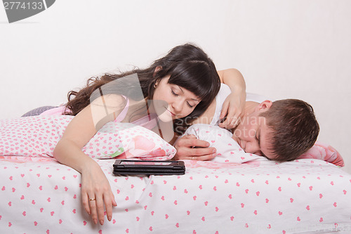 Image of Two young men fell asleep in bed