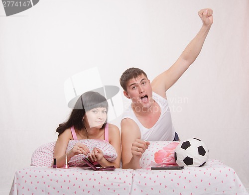 Image of Celebrates after scoring husband, wife watch soccer