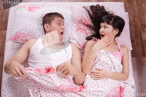 Image of Two strangers awake in bed