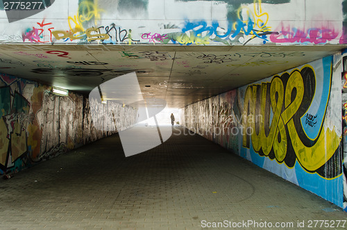 Image of underground crossing with graffiti smeared walls 