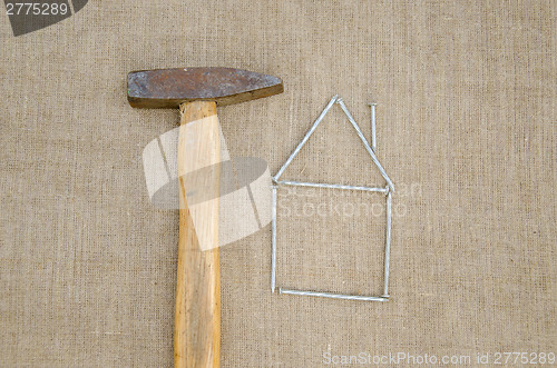Image of hammer and house made nail building home concept 