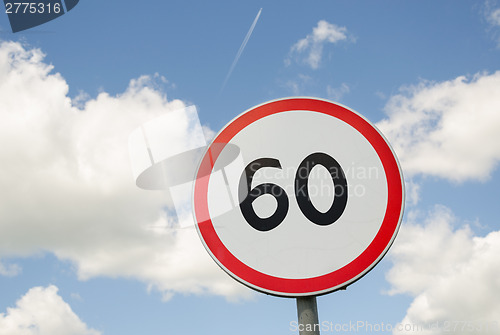 Image of road traffic round sign limiting speed on blue sky 