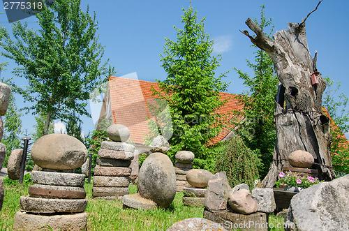 Image of stone composition in village in summer park 