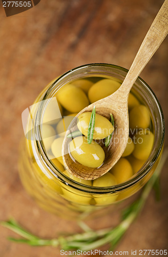Image of Close up green olives in bank,  rosemary