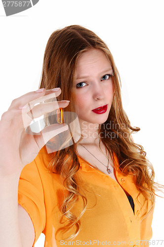 Image of Girl showing vitamin pill.