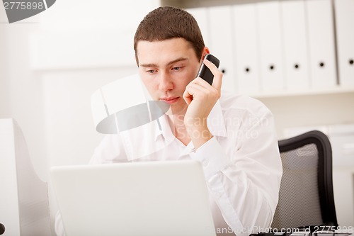 Image of man working and using laptop