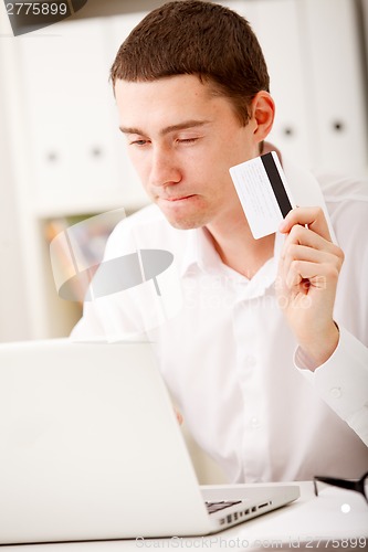 Image of man holding credit card