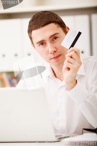 Image of man holding credit card