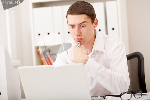 Image of man thinking in office