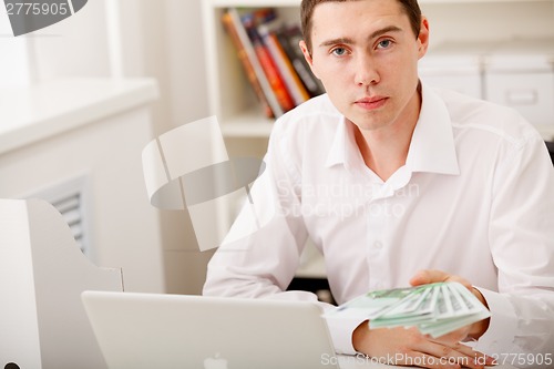 Image of man with Euro in office