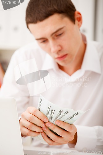 Image of man counting money