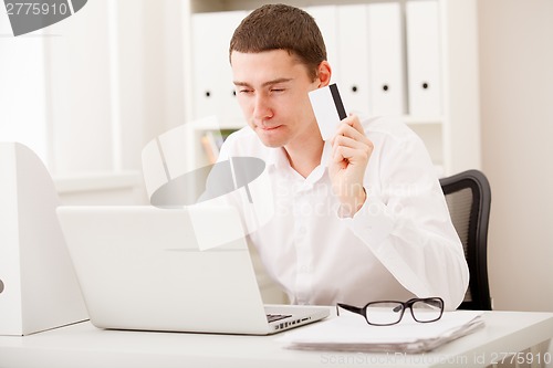 Image of man using credit card