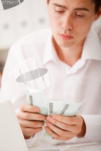 Image of man counting money