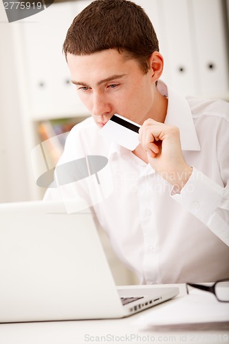 Image of man holding credit card