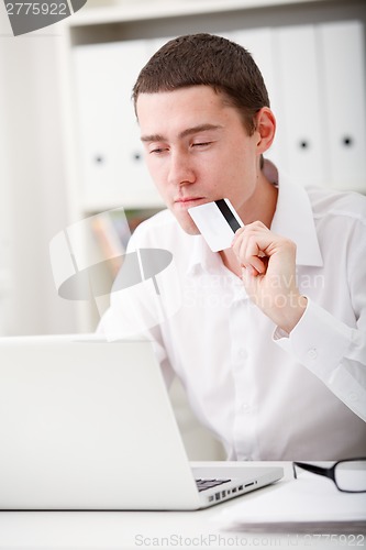 Image of man holding credit card