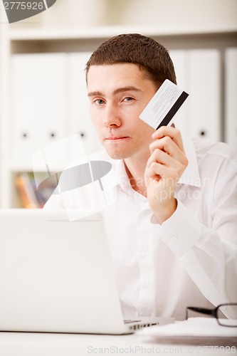 Image of man holding credit card