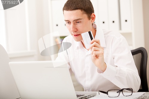Image of man using credit card