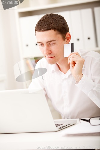 Image of man using credit card