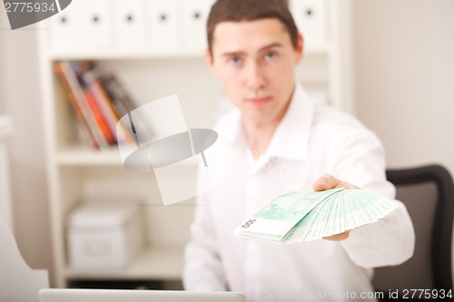 Image of man holding euro money