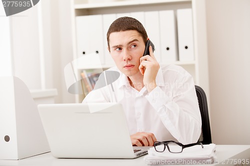 Image of businessman on phone sitting