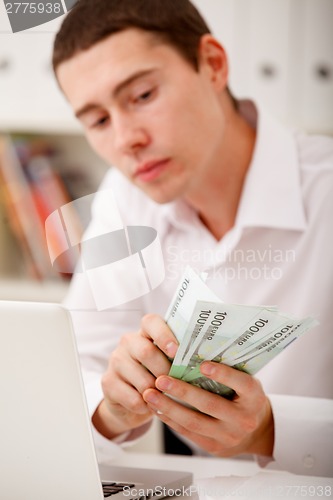 Image of man counting money