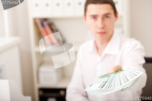 Image of man holding euro money