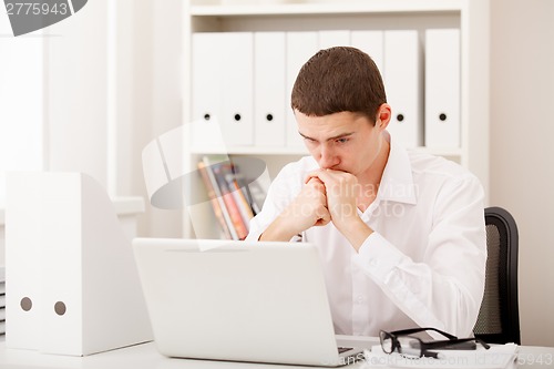 Image of man thinking in office