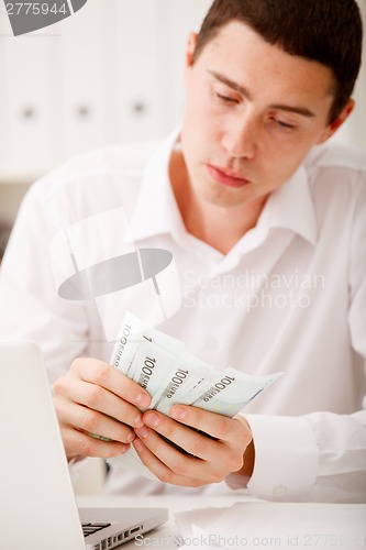 Image of man counting money