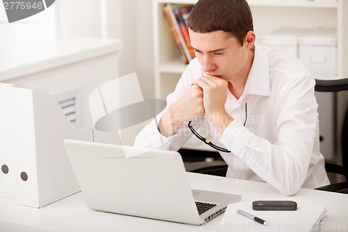 Image of man thinking in office